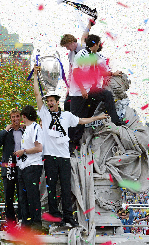 Real Madrid's Argentine player Santiago Solari holds the Champions League trophy as his teammates celebrate in central Madrid atop the landmark Cibeles fountain in the year 2002