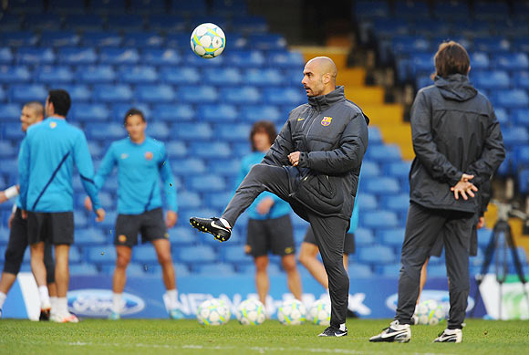 Coach Pep Guardiola of Barcelona shows off his footballing skills during a training session ahead of their UEFA Champions League semi-final against Chelsea