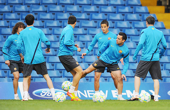 Xavi Hernandez (centre) of Barcelona in action during a training session