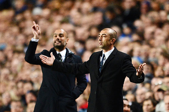 Roberto Di Matteo, caretaker manager of Chelsea gestures with Josep Guardiola, coach of Barcelona