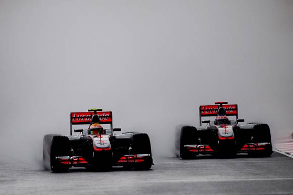 McLaren's Lewis Hamilton (left) next to his team-mate Jenson Button