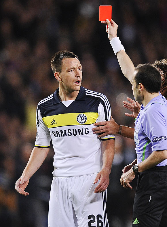 Chelsea captain John Terry (left) reacts as he is shown a red card by referee Cuneyt Cakir