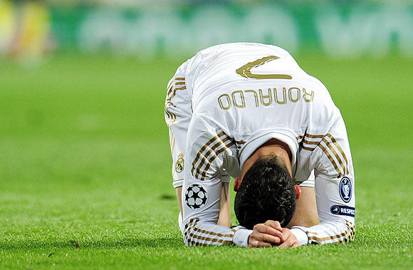 Cristiano Ronaldo reacts after missing a penalty during the shootout