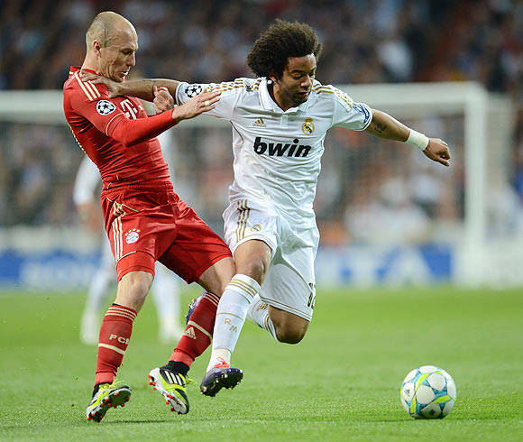 Bayern Munich's Arjen Robben and Real Madrid's Marcelo vie for possession
