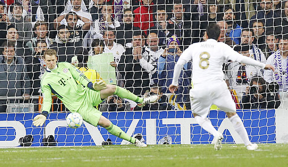 Real Madrid's Kaka (right) takes a penalty and fails to score past Bayern Munich's goalkeeper Manuel Neuer