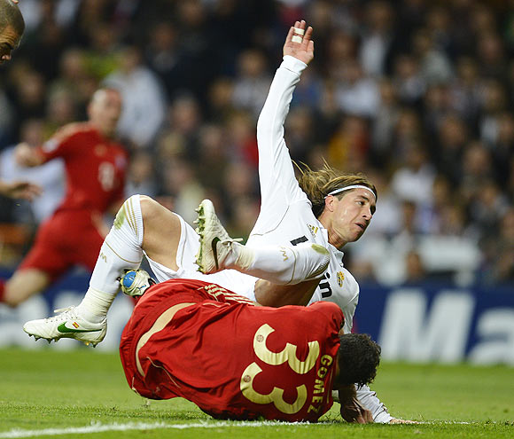 Bayern Munich's Mario Gomez is fouled by Real Madrid's Sergio Ramos to win a penalty