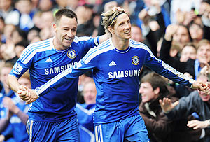 Chelsea's Fernando Torres celebrates with teammate John Terry as he scores their fifth goal and completes his hat trick against QPR on Sunday