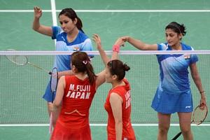 Ashwini Ponnappa (top right) and Jwala Gutta (left) shake hands with Mizuki Fujii (bottom left) and Reika Kakiiwa (right) of Japan after losing their women's doubles match.