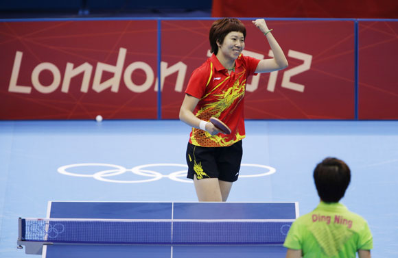 China's Li Xiaoxia celebrates a point against China's Ding Ning in their women's singles gold medal table tennis match