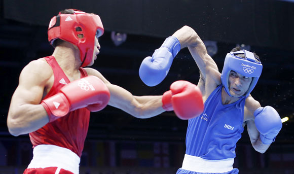 Kazakhstan's Gani Zhailauov (L) fights against India's Jai Bhagwan in their Men's Light (60kg) Round of 16 boxing match
