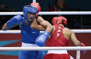 Kazakhstan's Gani Zhailauov, right, fights India's Bhagwan Jai during their men's light 60-kg boxing match