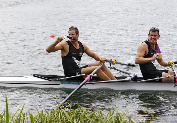 New Zealand's Nathan Cohen (back) and Joseph Sullivan smile with their gold medals at the victory ceremony after winning the men's double sculls finals rowing event