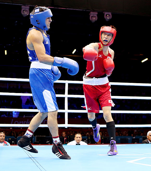 Satoshi Shimizu of Japan (right) in action against Magomed Abdulhamidov of Azerbeijan during the Men's Bantam (56kg) boxing event on Wednesday