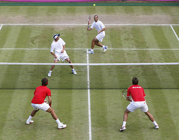 Israel's Andy Ram (top, right) and Jonathan Erlich play a volley against Switzerland's Roger Federer and Stanislas Wawrinka (bottom, right) during their men's doubles match during the London 2012 Olympics on Wednesday