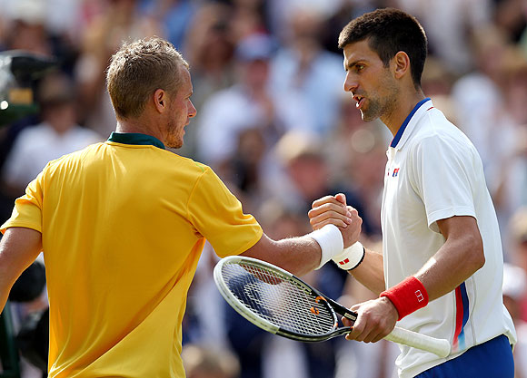 Novak Djokovic (right) of Serbia greets Lleyton Hewitt of Australia after defeating him in the third round match on Wednesday
