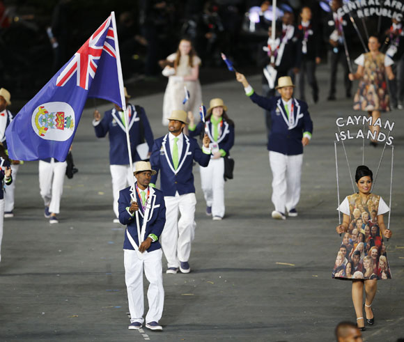 Cayman Islands' flag bearer Kemar Hyman holds the national flag as he leads the contingent in the athletes parade during the opening ceremony of the London 2012 Olympic Games