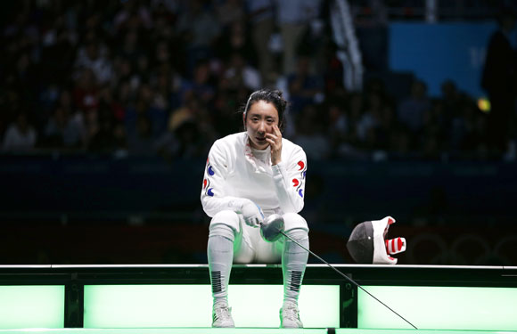 South Korea's Shin A Lam reacts after being defeated by Germany's Britta Heidemann (not seen) during their women's epee individual semifinal fencing competition