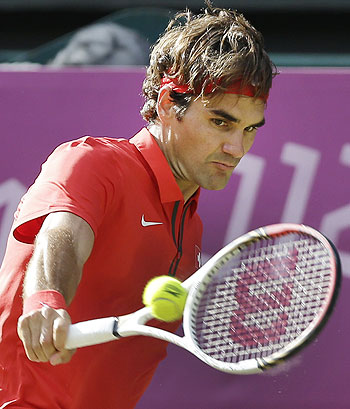 Roger Federer of Switzerland returns to John Isner of the United States at the All England Lawn Tennis Club on Thursday