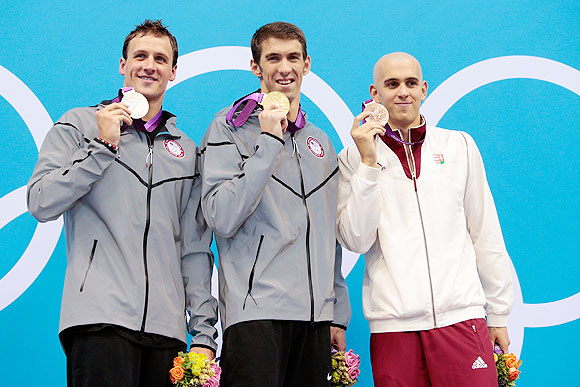 Silver medallist Ryan Lochte of the United States, gold medallist Michael Phelps of the United States and bronze medallist Laszlo Cseh of Hungary pose on the podium during the medal ceremony after the Men's 200m Individual Medley final on Thursday