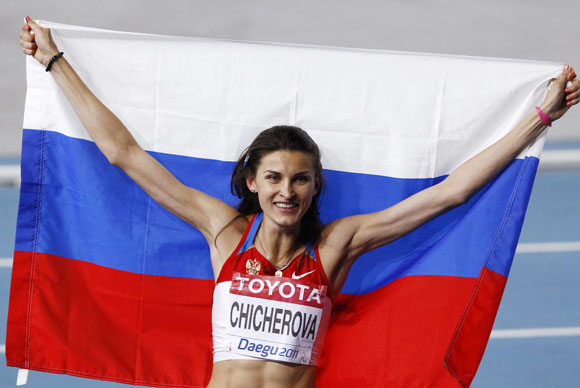 Anna Chicherova of Russia holds her national flag after winning the gold medal in the women's high jump final at the IAAF World Athletics Championships in Daegu