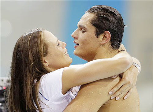France's Florent Manaudou is embraced by his sister Laure after winning
