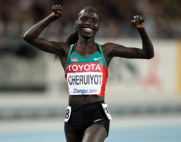 Vivian Jepkemoi Cheruiyot of Kenya celebrates as she crosses the finish line to win the women's 10,000 metres final during day one of the 13th IAAF World Athletics Championships at the Daegu Stadium