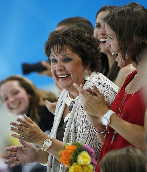 Debbie Phelps, left, and Whiney, right, mother and sister respectively of United States' Michael Phelps, applaud