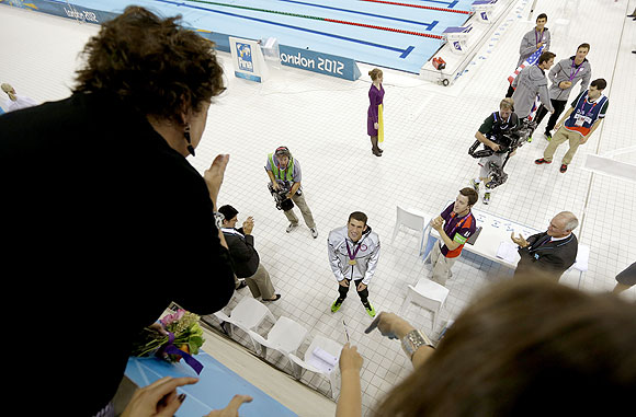 Michael Phelps, center, looks up at his mother, Debbie