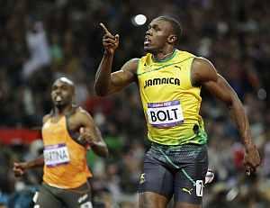 Usain Bolt celebrates after crossing the finish