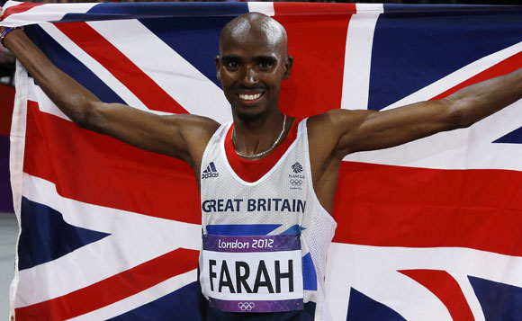 Britain's Mo Farah holds the Union Flag after winning the men's 10,000m final