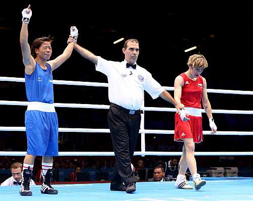 Mary Kom of India celebrates after winning her bout against Karolina Michalczuk of Poland