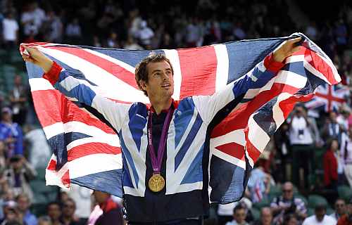 Gold medalist Andy Murray of Great Britain waves the British flag during the medal ceremony of the men's singles event at the All England Lawn Tennis Club