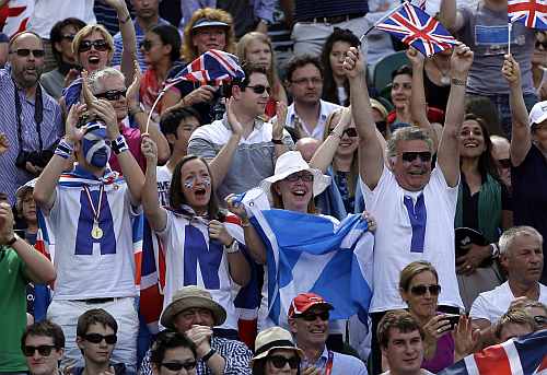 Fans of Andy Murray of Great Britain cheer during his match against Roger Federer of Switzerland during the gold medal men's singles