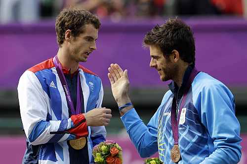 Gold medalist Andy Murray of Great Britain, left, shakes hands with bronze medalist Juan Martin del Potro of Argentina, right, during the medal ceremony of the men's singles event