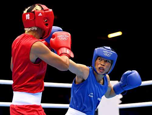 Mary Kom of India competes against Maroua Rahali (Red) of Tunisia during the Women's Fly (51kg) Boxing quarter-finals