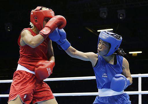 India's Chungneijang Mery Kom Hmangte, right, fights Tunisia's Maroua Rahali during a women's flyweight 51-kg quarterfinal boxing match