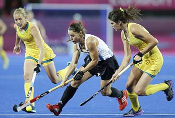 Argentina's Sofia Maccari (centre) runs with the ball, during a preliminary round women's hockey match against Australia at the Riverside Arena at the 2012 Summer Olympics on Monday