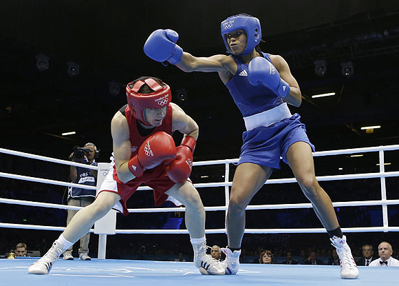 Ireland's Katie Taylor (left) ducks a punch from Britain's Natasha Jonas in a women's lightweight 60-kg quarter-final boxing matchon Monday
