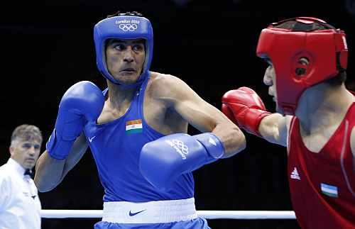 Uzbekistan's Abbos Atoev fights India's Vijender during their quarterfinal Men's Middle (75kg) boxing match at the London Olympic Games