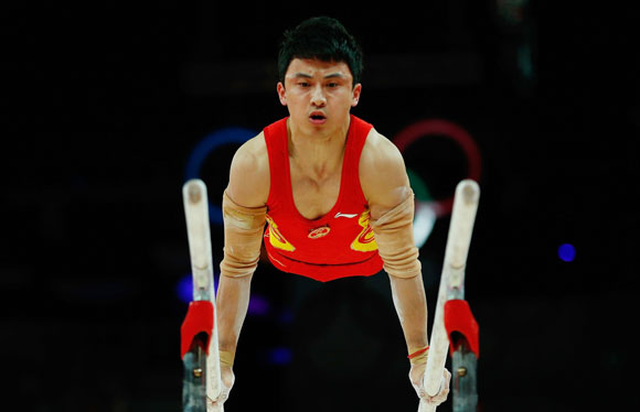 China's Feng Zhe competes in the men's gymnastics parallel bars final in the North Greenwich Arena
