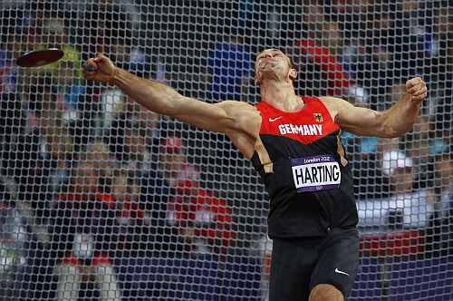 Germany's Robert Harting takes a throw in the men's discus throw final during the athletics in the Olympic Stadium