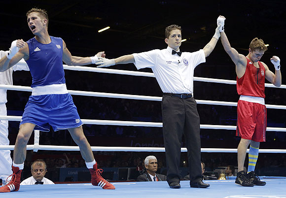 Alexis Vastine of France (left) reacts after the referee names Taras Shelestyuk of Ukraine, as the winner after their welterweight 69-kg quarter-final bout on Tuesday