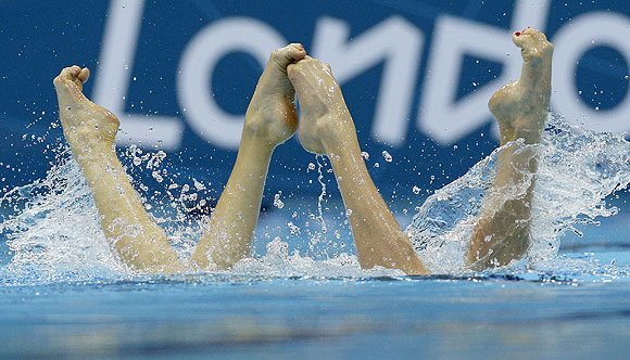 Natalia Ishchenko and Svetlana Romashina from Russia compete during the women's duet synchronized swimming free routine