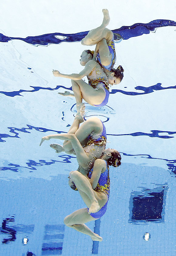 Huang Xuechen and Liu Ou of China compete during women's duet synchronized swimming final on Tuesday