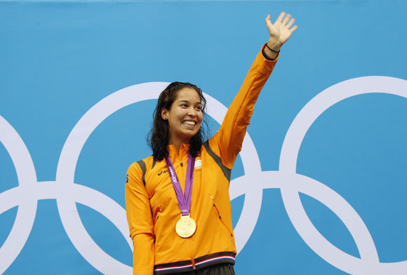 Ranomi Kromowidjojo of the Netherlands waves after she received her gold medal during the women's 100m freestyle victory ceremony