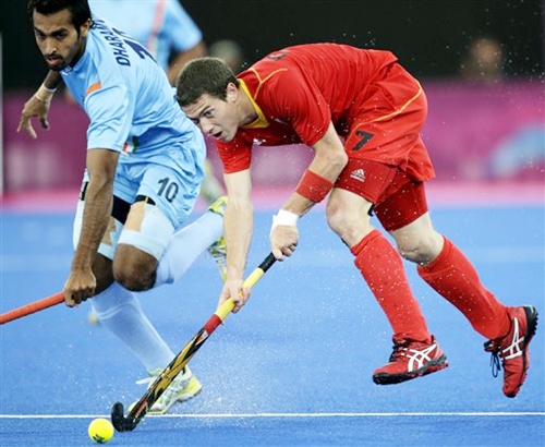 Belgium's John-John Dohmen (7) and India's Dharamvir Singh (10) battle for control of the ball