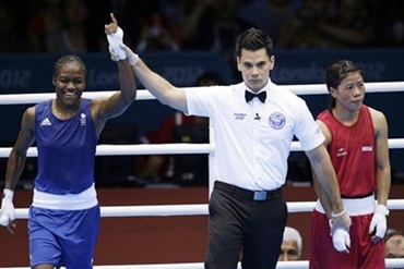 The referee raises Nicola Adams's hand after the semi-final against Mary Kom