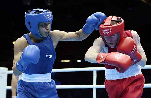 Ireland's Paddy Barnes, right, fights India's Devendro Singh Laishram in a light flyweight 49-kg quarterfinal boxing match at the 2012 Summer Olympics
