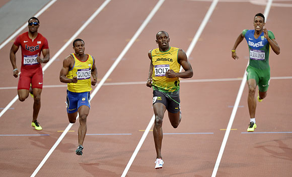 Jamaica's Usain Bolt crosses the finish line ahead of United States' Isiah Young (left), Ecuador's Alex Quinonez and Brazil's Aldemir Da Silva Junior (right) in the men's 200-meter semi-final on Wednesday
