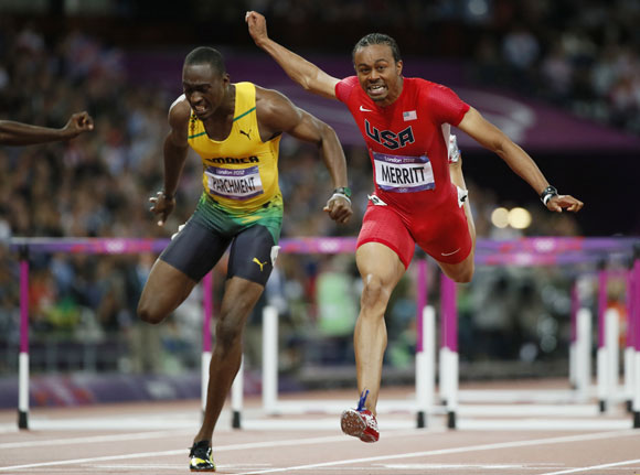 Aries Merritt of the U.S. (R) finishes first of Jamaica's Hansle Parchment during their men's 110m hurdles final